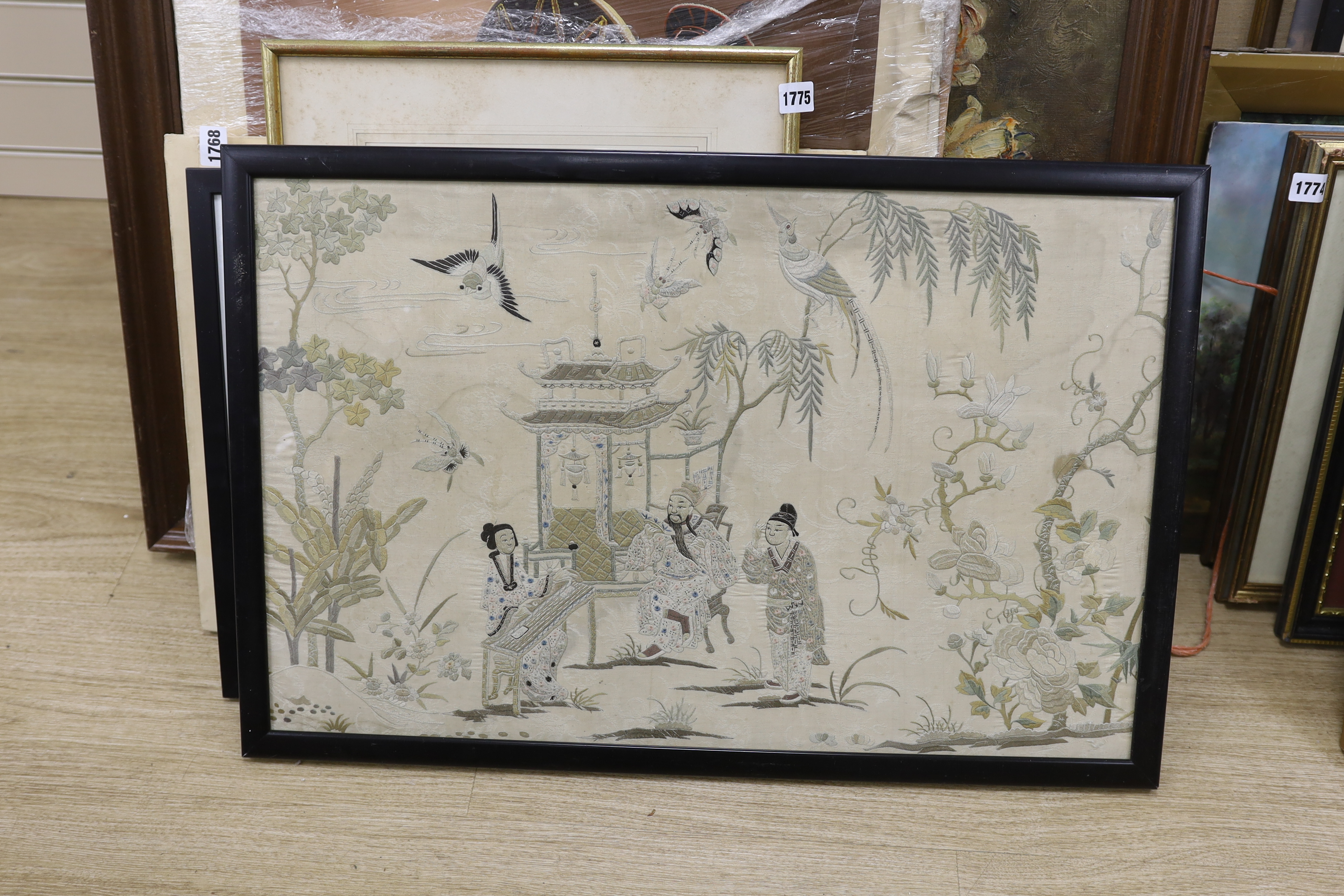 A late 19th century Chinese embroidered silk panel depicting noblemen and attendants in a garden, 44 x 70cm